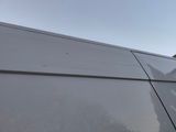 a cat that is sitting on the roof of a van