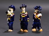 three figurines of a man with a baseball bat and a baseball glove