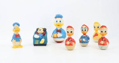 a group of toy figurines of donald and daisy duck