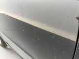a close up of a car door with a spider web on it
