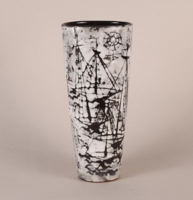 a black and white picture of a vase with a ship on it