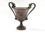 a silver cup that is sitting on top of a table