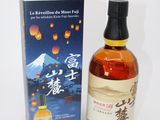 bottle of japanese whisky with box on white background with mountain in background
