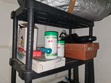 a black shelf with a bag on top of it next to a pair of shoes