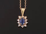 a blue sapphire and diamond pendant on a gold chain