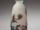 a white vase with a picture of birds on it
