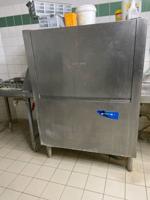 a stainless steel refrigerator in a kitchen with a lot of counter space
