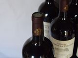 several bottles of wine are lined up on a table