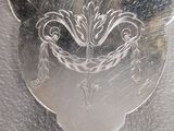 a fork with a design on it sitting on a table
