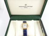 a box with a watch inside of it on a white surface