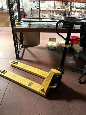 a forklift that is sitting on the floor in a warehouse