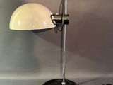 a lamp that is sitting on a table next to a wall