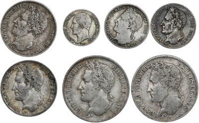 a group of six silver coins with heads of men and women on them