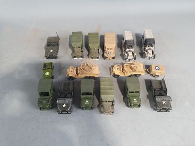 a lot of toy army vehicles and trucks on the table