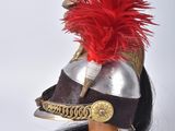 an image of a helmet with a red feather on top of it