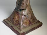 statue of a woman holding a bird on a pedestal