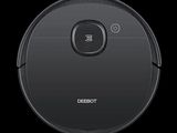 a close up of a robot vacuum cleaner on a black background