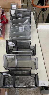 many bins of items on a table in a store