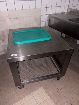 a metal table with a blue tray on it