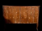 a very old wooden dresser with a lot of paint on it