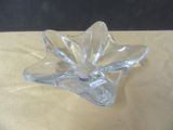 a clear glass flower shaped object on a table
