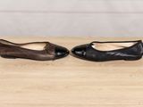 a pair of black and brown shoes sitting on top of a wooden table