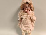 a small doll that is standing up against a wall