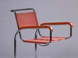 an orange chair with a metal frame and a leather seat