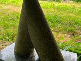 a stone sculpture of two cones on top of a stone block
