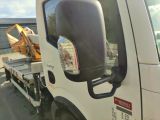 a white truck with a flat bed and a crane on the back of it