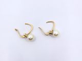 a pair of pearl earrings on a white background