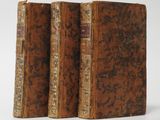a pair of old books sitting on top of each other