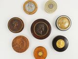 several different types of buttons are arranged on a white surface