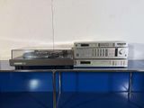 a turntable with a cd player on top of it