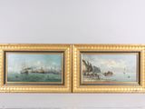 pair of oil paintings of ships in the water by a fireplace