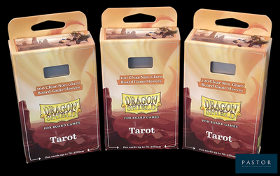 three boxes of tarot sitting next to each other on a black surface