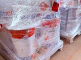 many bags of cement sitting on pallets in a warehouse