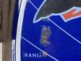 a close up of a blue and white sign with a bird on it