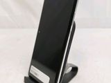 a cell phone that is on a stand on a table