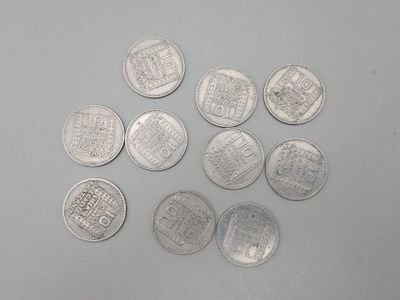 six types différents de pièces d'argent sur une surface blanche