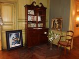 a picture of a corner of a room with a chair and a cabinet