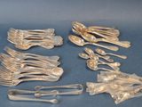 a lot of silver spoons and forks on the table