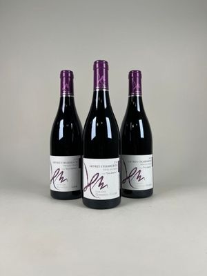 trois bouteilles de vin sont alignées sur une table