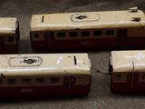 three small toy trains sitting on top of a table next to each other