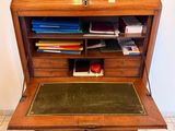 a small desk with a lot of books on top of it