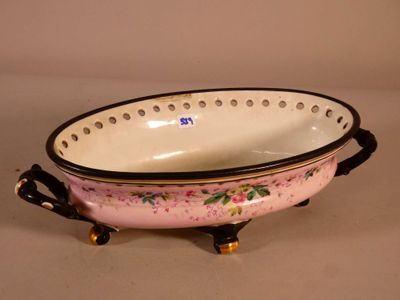 a pink and black bowl on a stand on a table