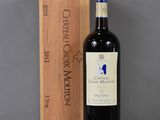 a bottle of wine sitting next to a wooden box