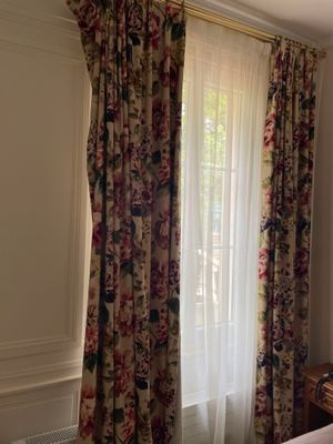 a bedroom with a bed and a window with curtains
