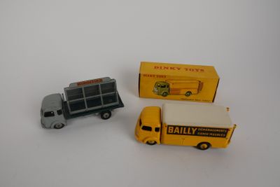 two toy trucks that are next to each other on a table