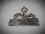 a metal object with horns on it on a white surface